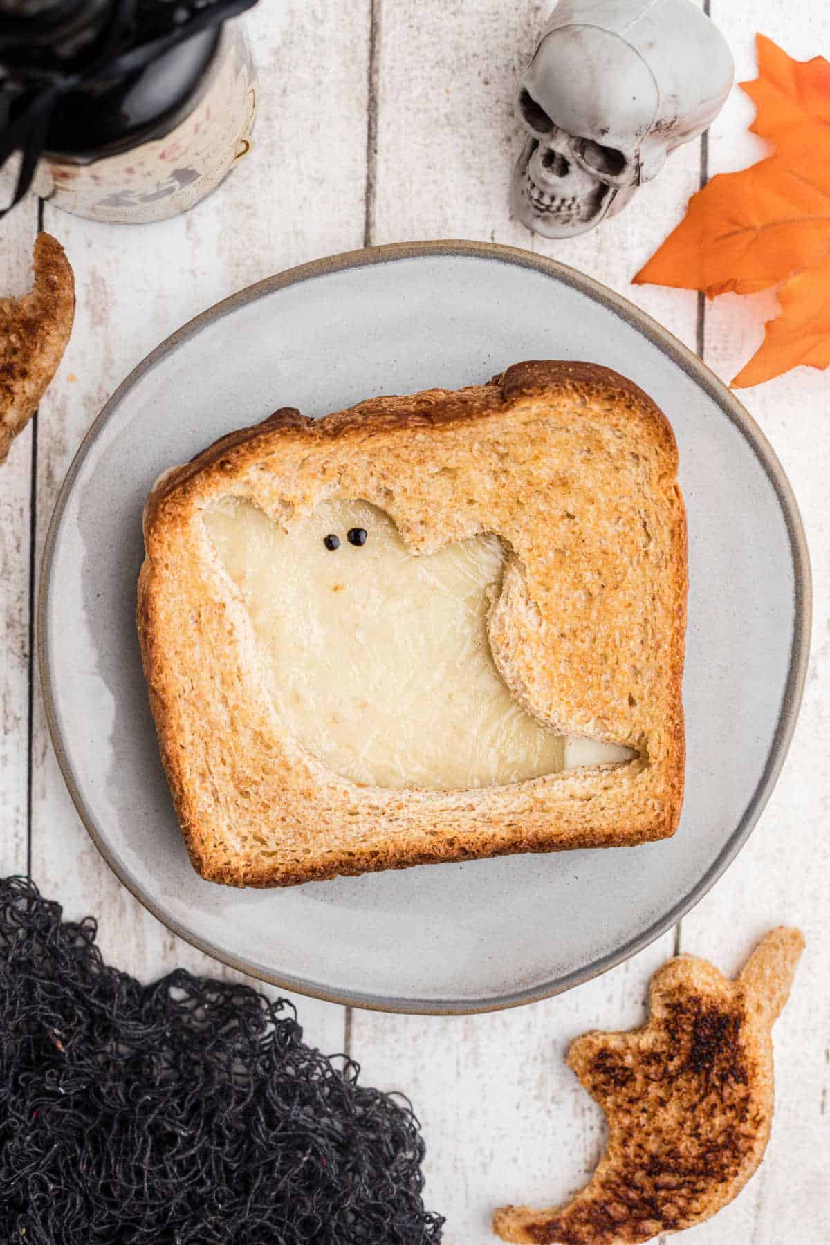 Overhead close up shot of a halloween grilled cheese ghost shaped.