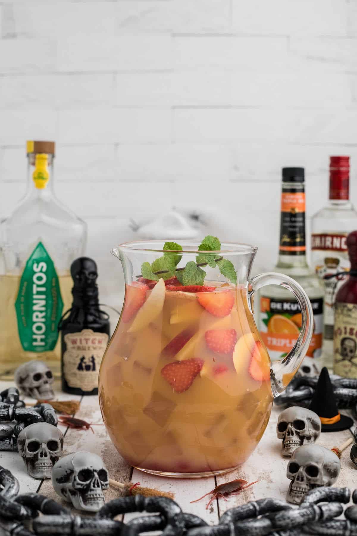 Pitcher of Jungle juice with halloween deocrations.