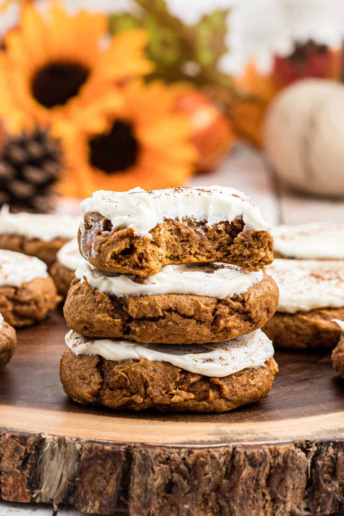 A stack of 3 pumpkin spice cookies with a bite taken from one.