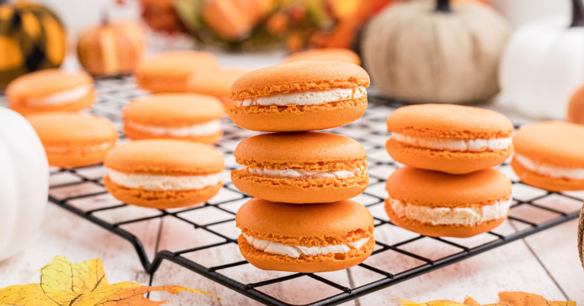 a stack of three pumpkin spice macarons.