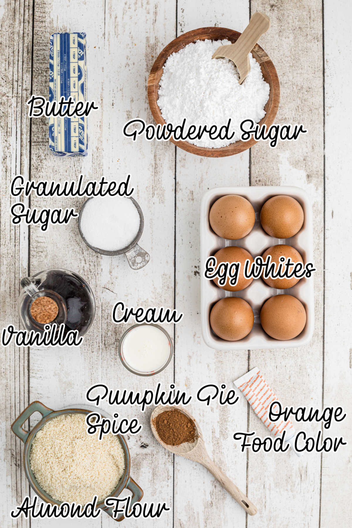 An overhead shot of ingredients needed to make pumpkin spice macarons, the ingredients have text overlay.