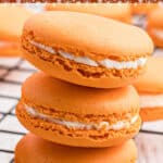 a stack of 3 pumpkin spice macarons with some text overlay for pinterest.