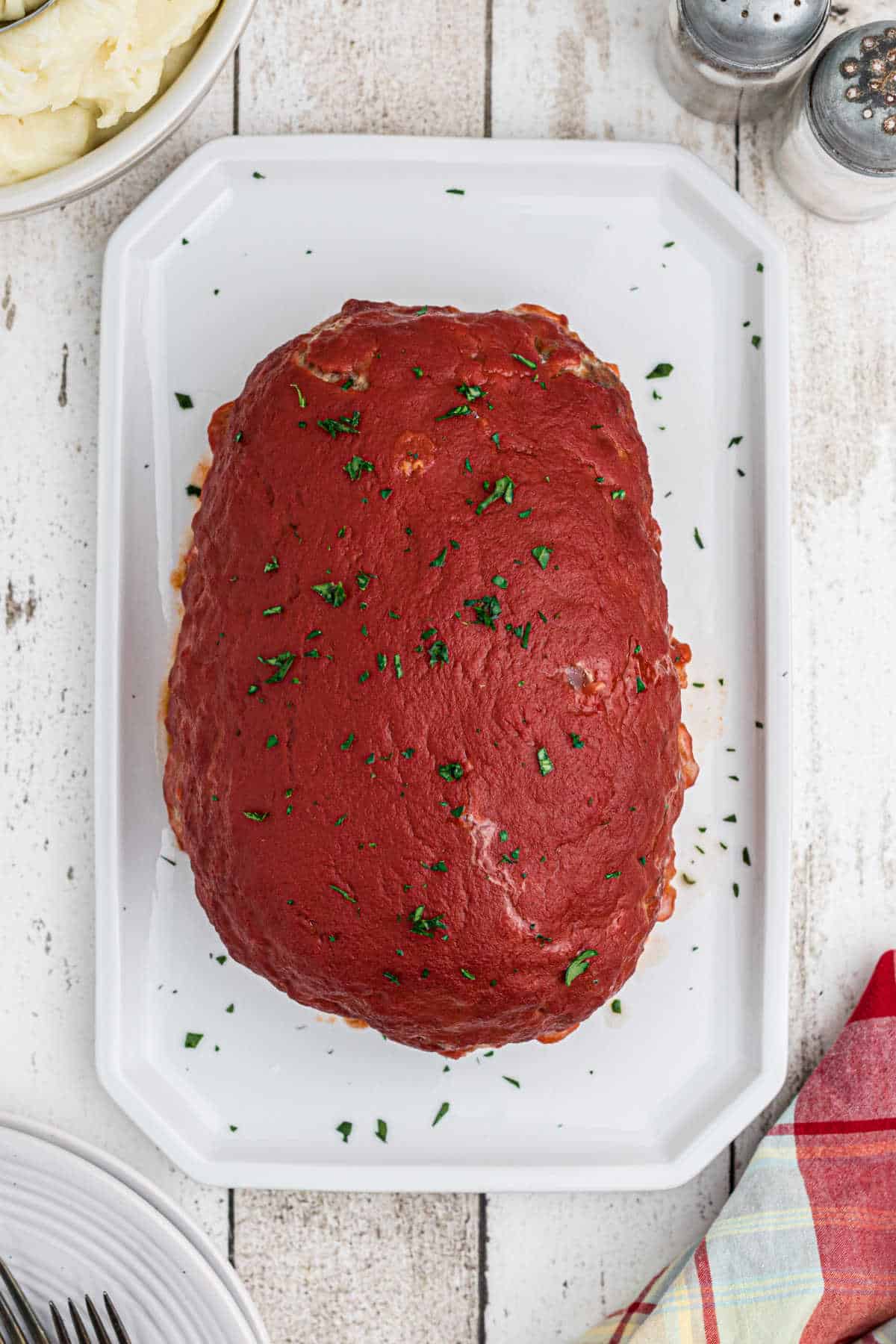 Overhead shot of a meatloaf with tomato sauce on top.