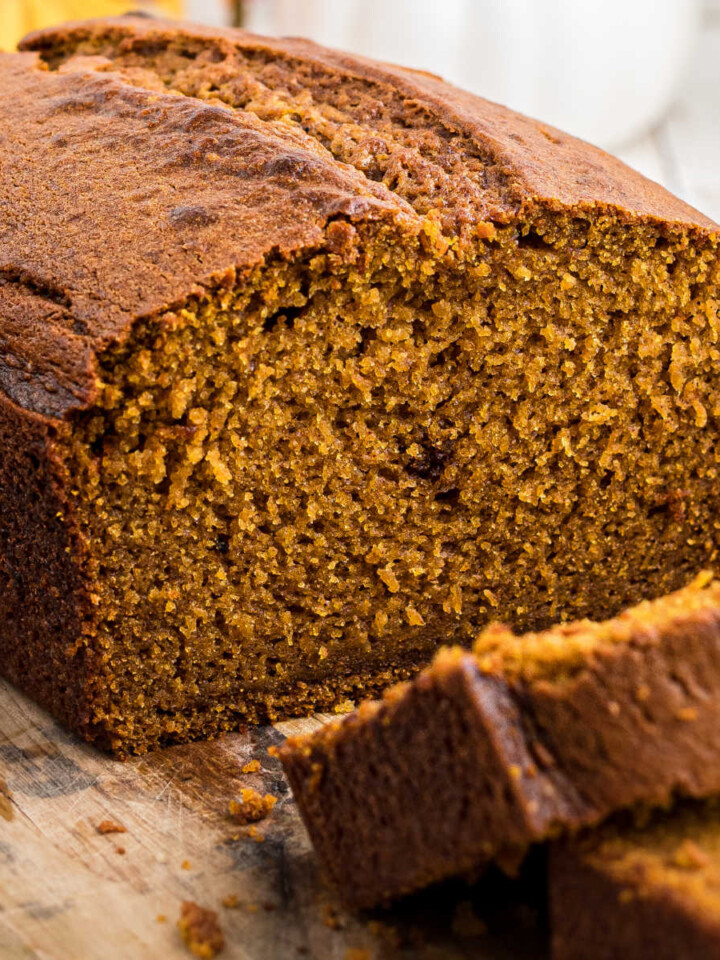 Close up side view of an Amish Pumpkin bread with slices taken from it.