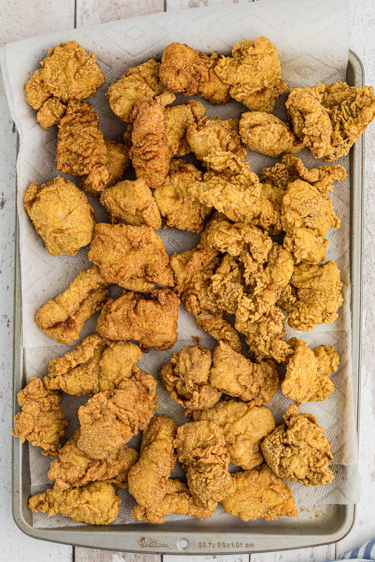 Overhead shot of a baking sheet full of fried fish.