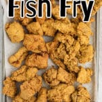 A baking sheet full of fish with a text overlay for pinterest.