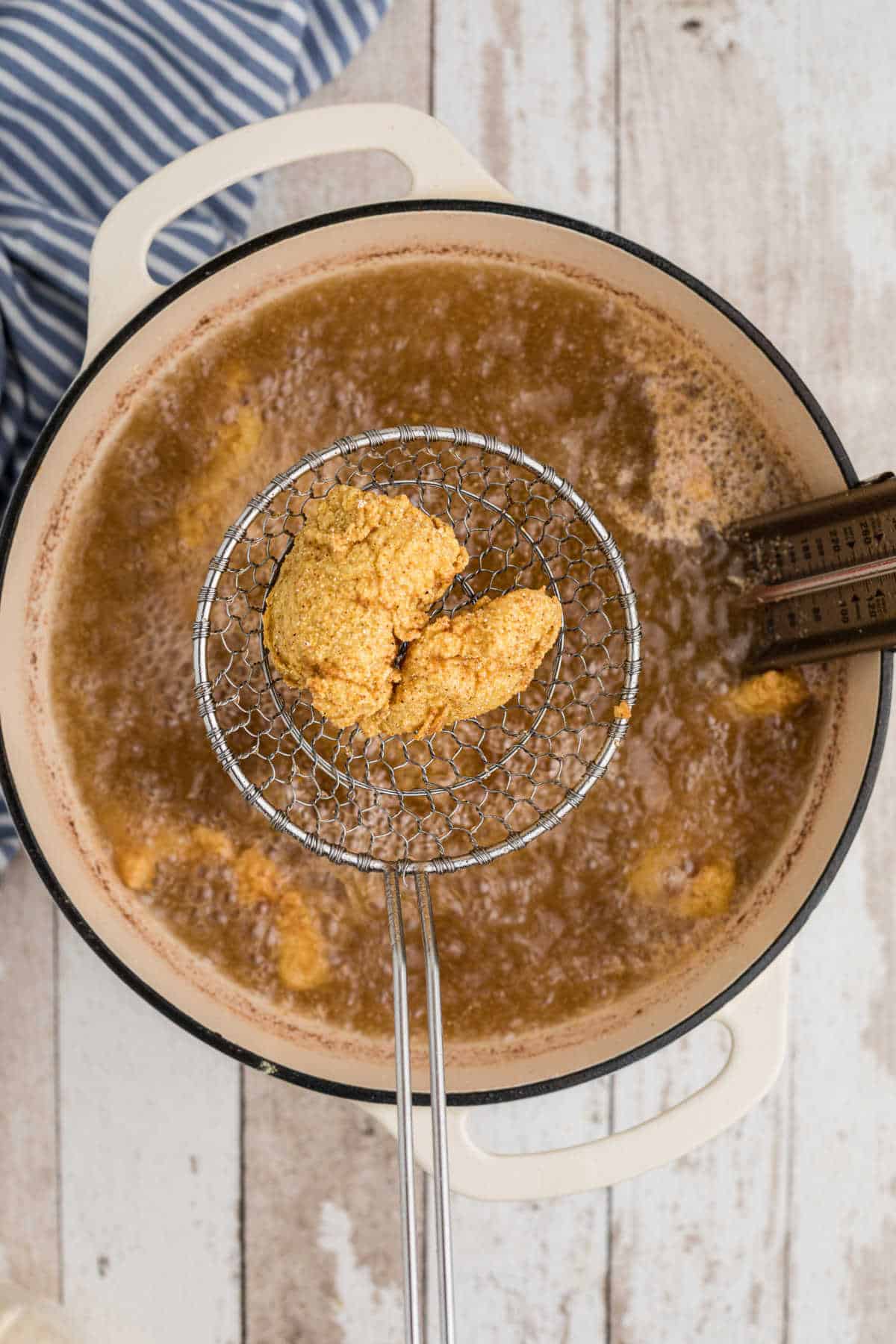 overhead shot of some fish frying in a pot.