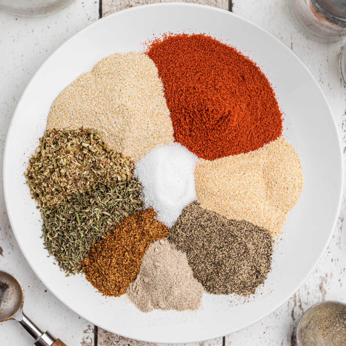 A plate full of arranged seasoning in a circle.