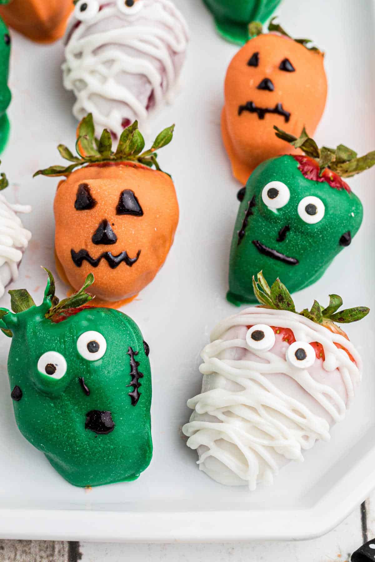 Close up of some Halloween chocolate strawberries - with a mummy, frankenstein and a jackolantern.