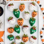 Long image with a plate of Halloween chocolate covered strawberries with text overlay for pinterest.