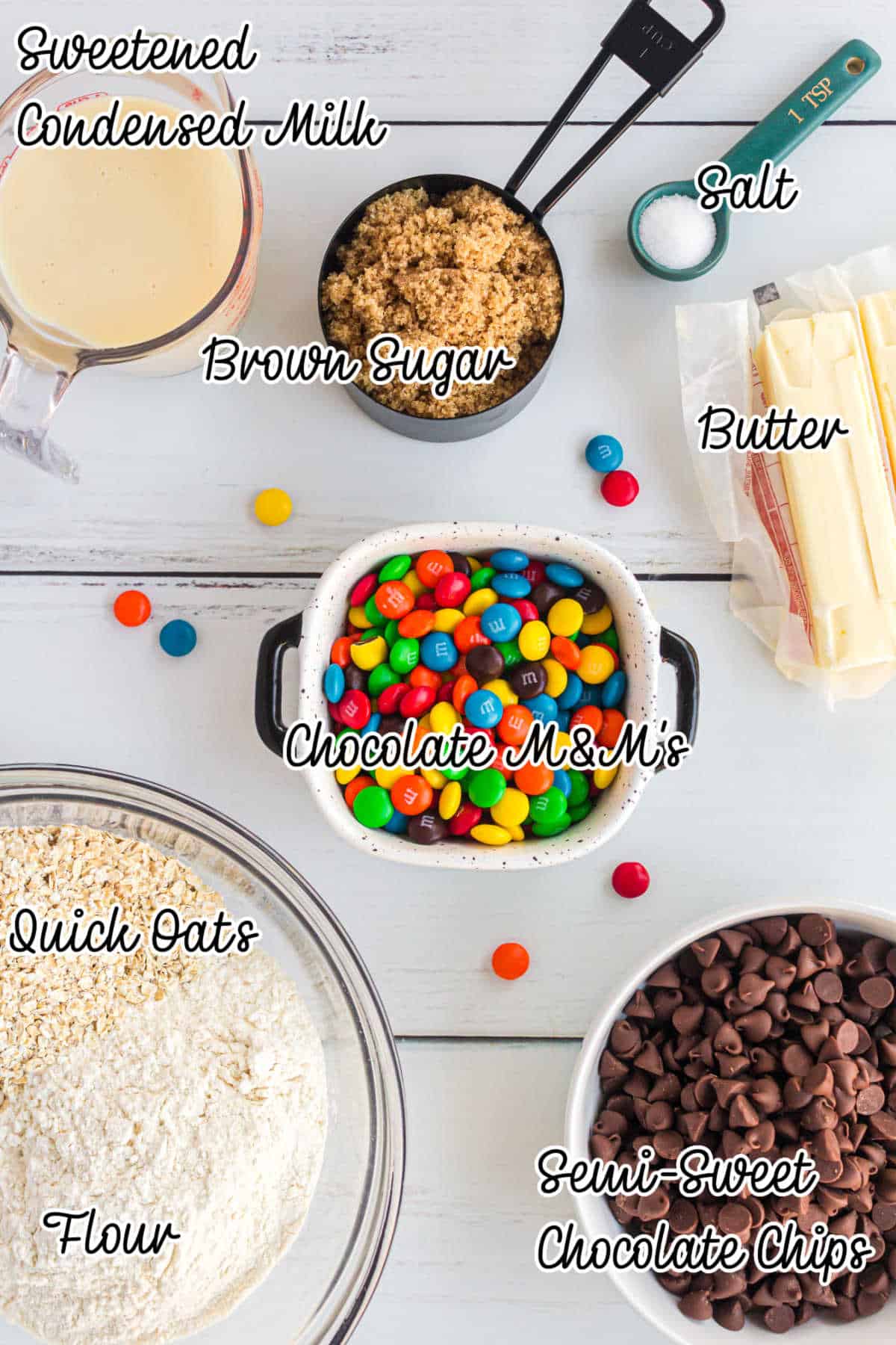 Ingredients laid out that's needed for making M&M Chocolate Oat Bars, with text overlay.