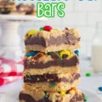 A stack of M&M Chocolate Oat Bars with some text overlay for pinterest.