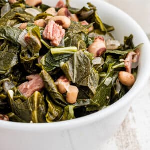 Close up of a bowl of southern black eyed peas and collard greens.