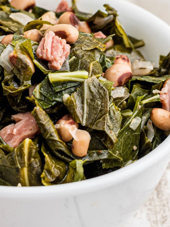 Close up of a bowl of southern black eyed peas and collard greens.