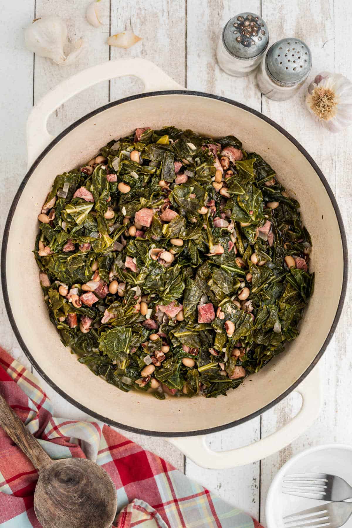 Overhead shot of a Dutch Oven full of black eyed peas and collard greens.