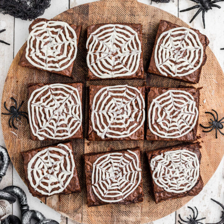 overhead shot of a board with spider web brownies.