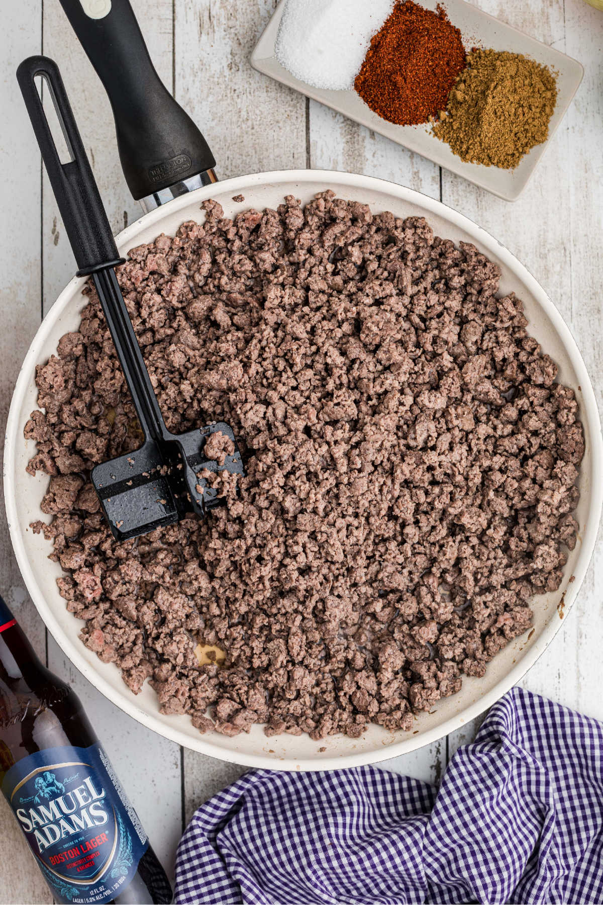 Ground meat browning in a large skillet.