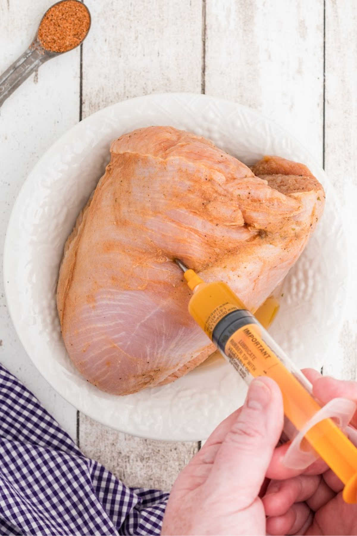 Marinade being injected into a turkey breast.