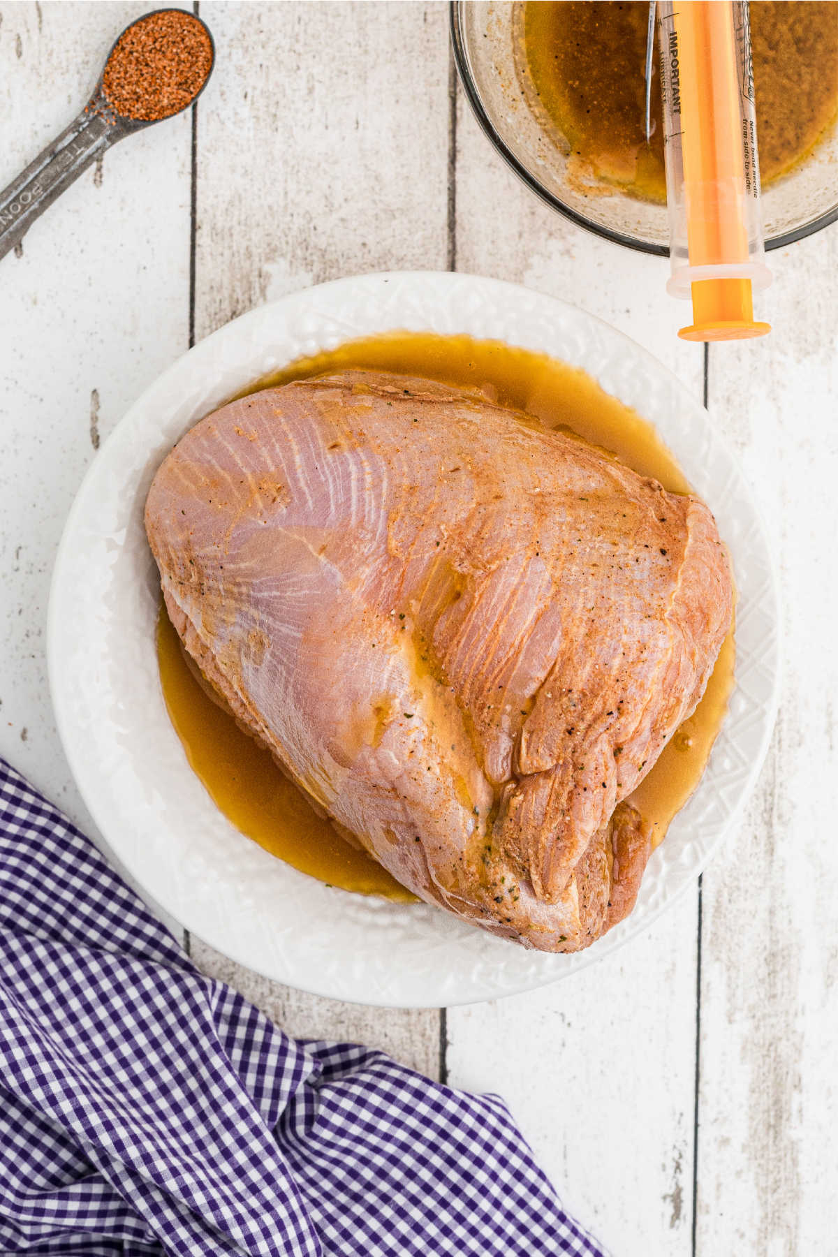 A turkey breast sitting in a marinade.