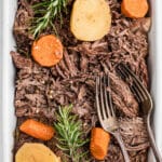 A long image of a dish of tri tip roast with potatoes and carrots in it and some forks with text overlay for pinterest.