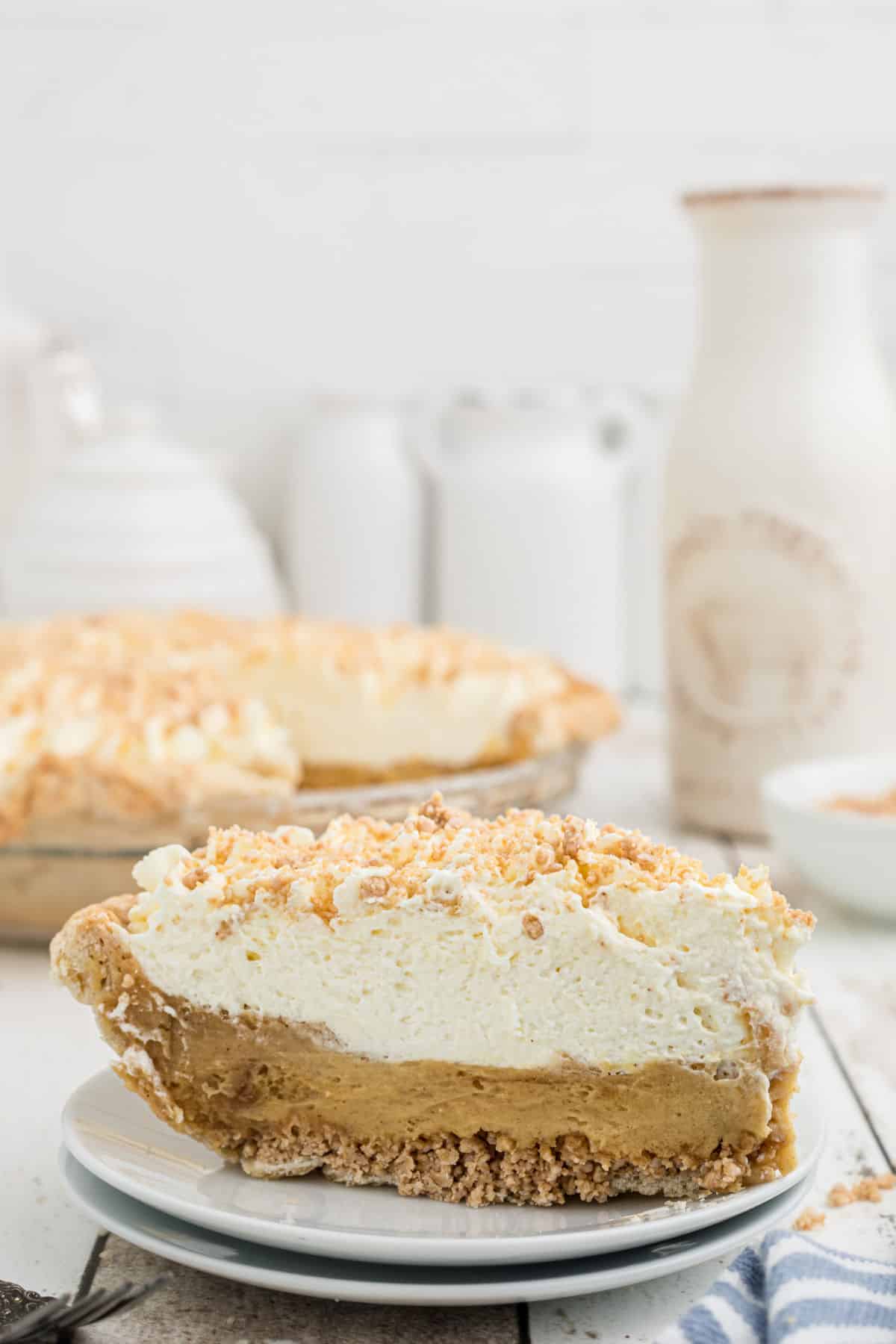 A slice of Amish Peanut Butte rPie with a pie dish behind.