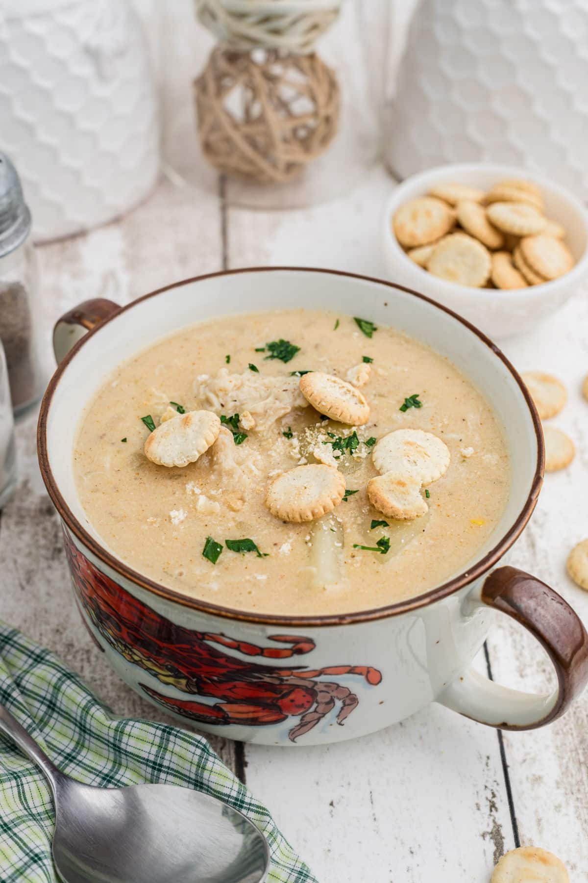 Portrait shot of a bowl of crab chowder in a crab bowl.