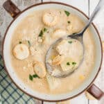 An overhead shot of a bowl of crab chowder with text overlay for pinterest.