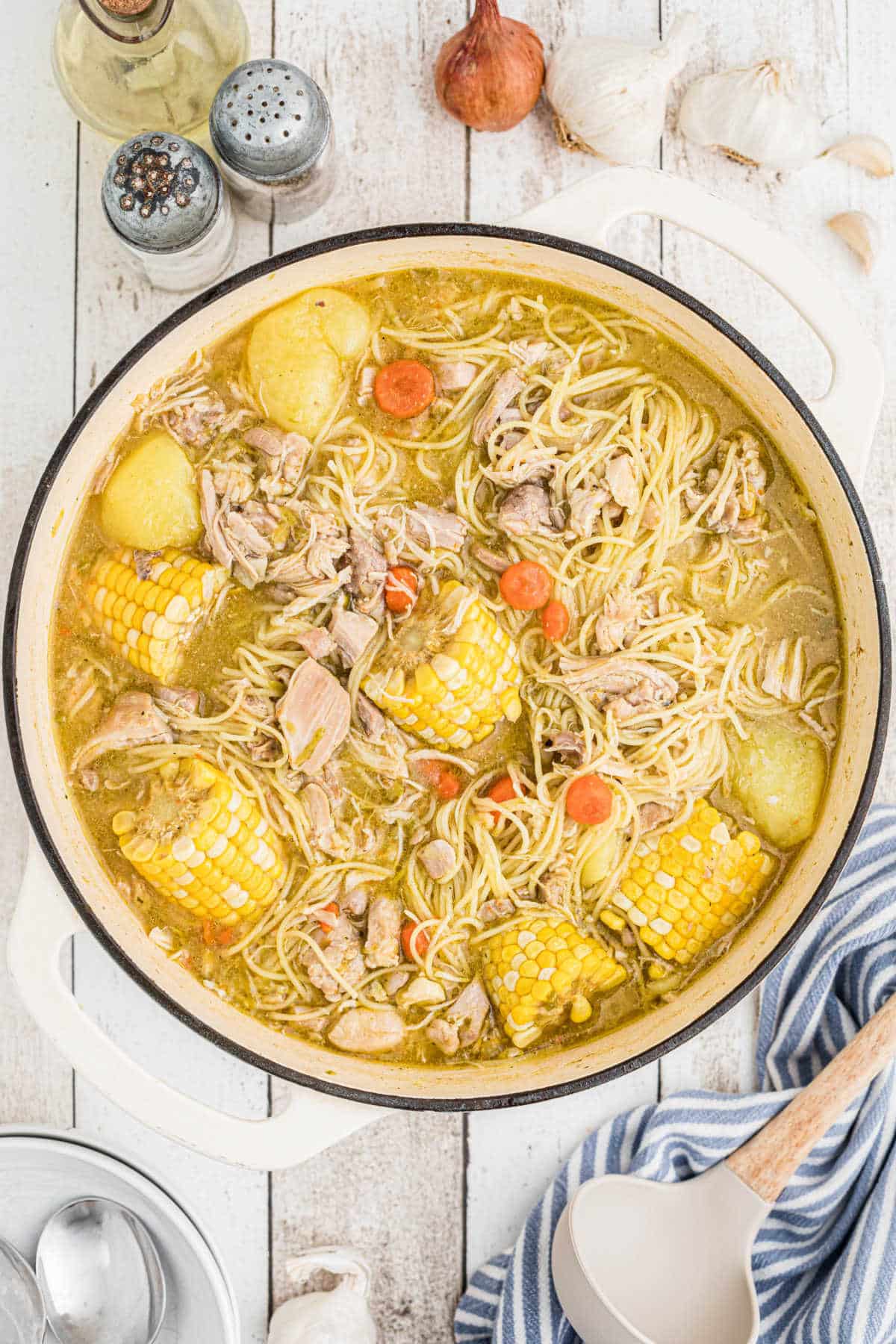 An overhead shot of a pot full of Cuban chicken soup.