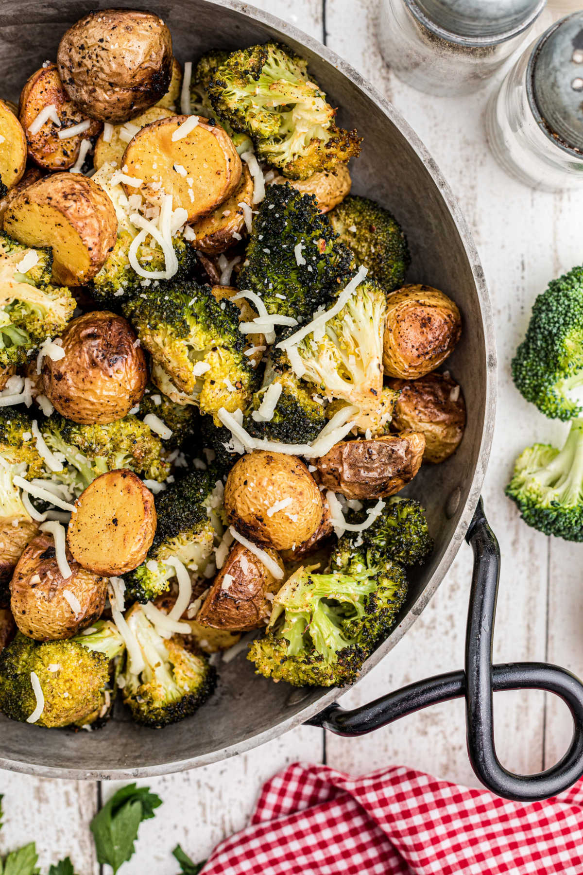 Overhead close up shot of a pan of roasted potatoes and broccoli.