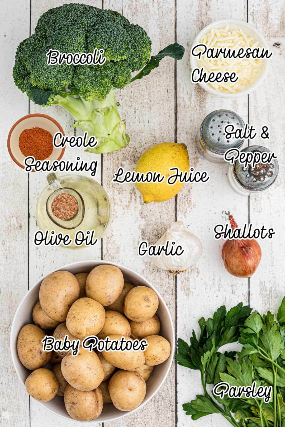 Ingredients needed to make roasted potatoes and broccoli, all laid out with text overlay.