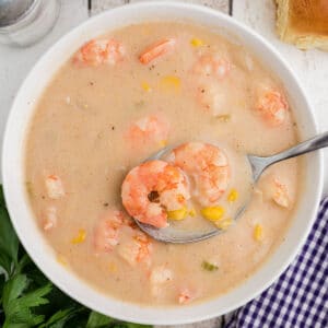 cropped square image of a bowl of shrimp and corn bisque.