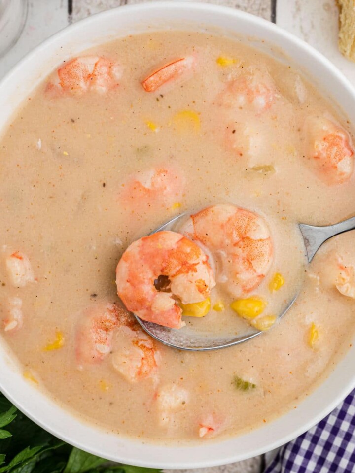 cropped square image of a bowl of shrimp and corn bisque.