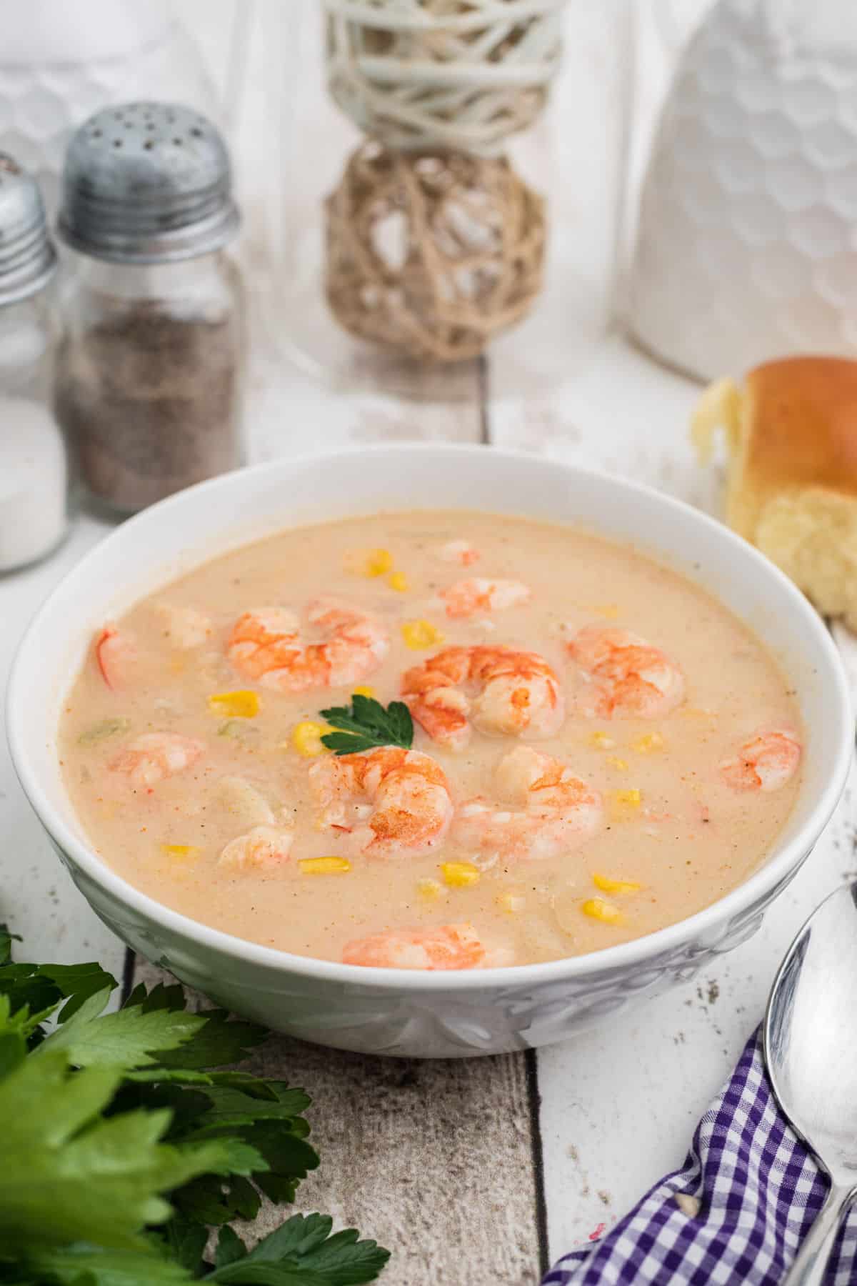 Side shot of a bowl of shrimp and corn bisque.