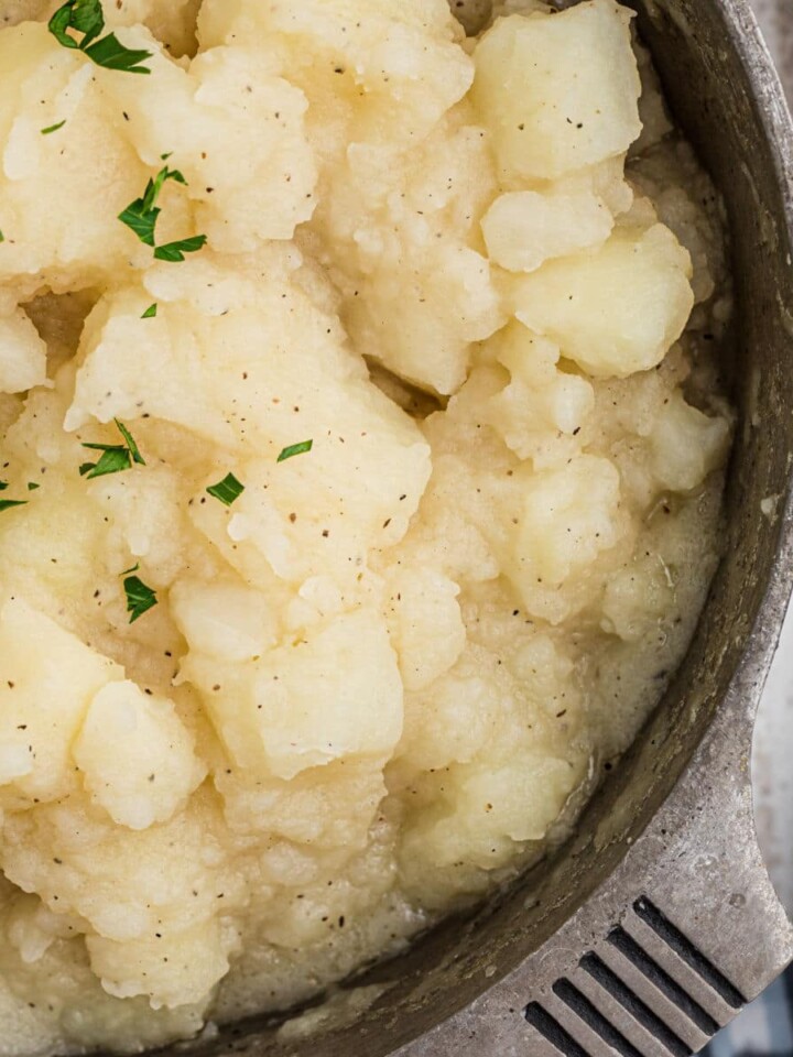 Close up shot of a pot of stewed potatoes.