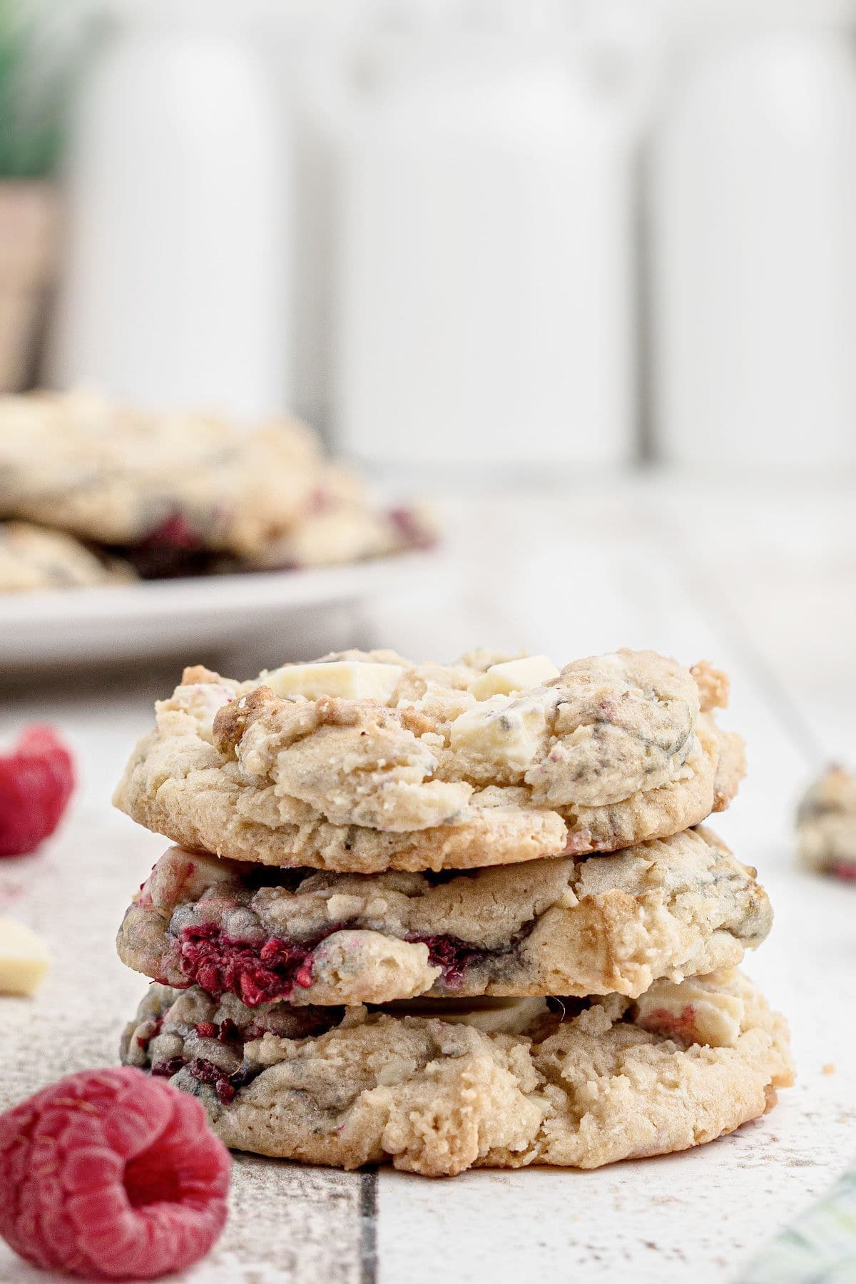 side view of a stack of white chocolate raspberry cookies.