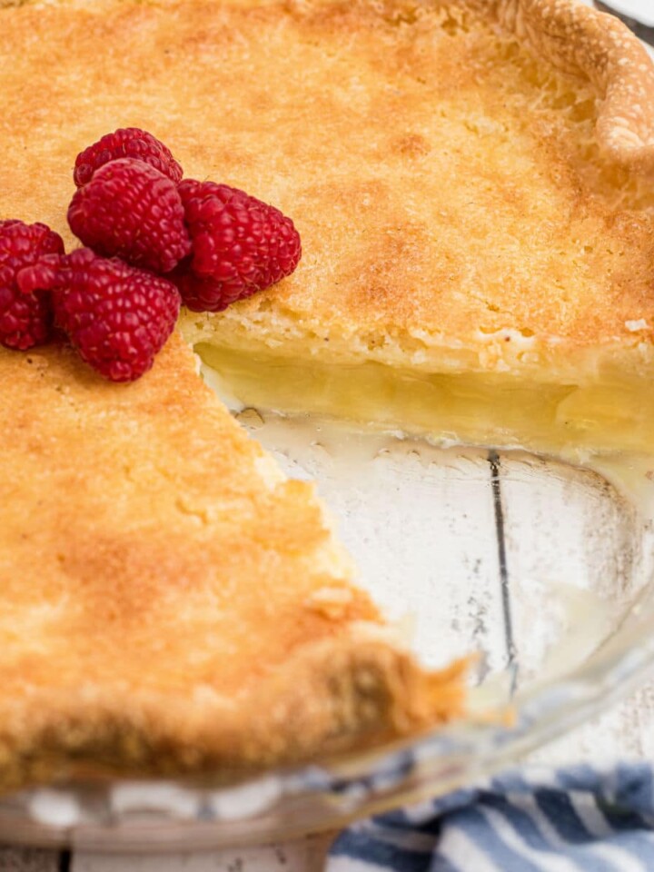 Close up shot of a cracker barrel buttermilk pie recipe with a slice taken out of it.