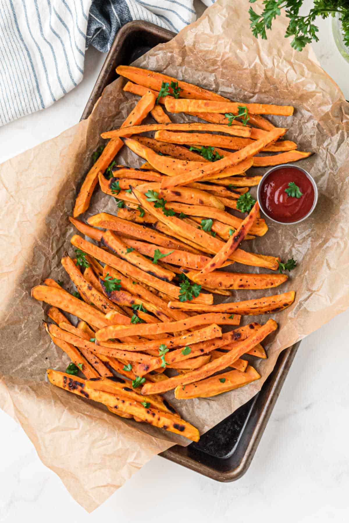 Sweet potato fries on a baking tray from overhead.