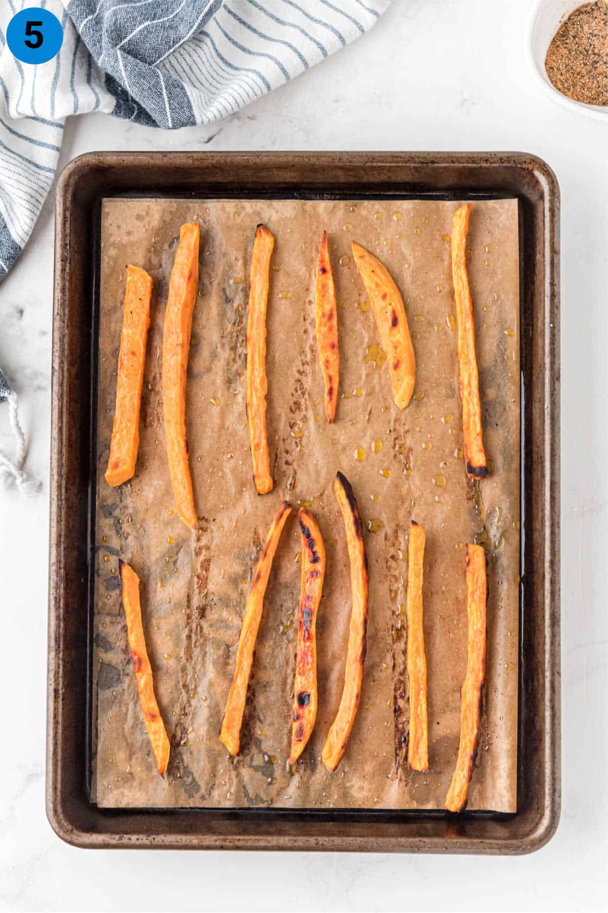 A baking sheet with crispy sweet potatoes.