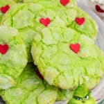 Side view of a plate of Grinch cookies with text overlay for pinterest.