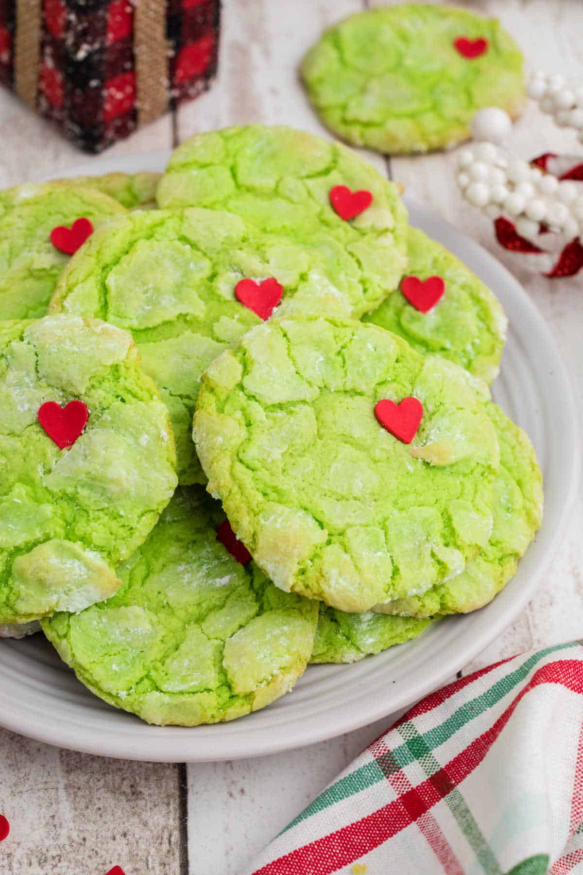 Close up of the side of a plate filled with Grinch cake mix cookies.