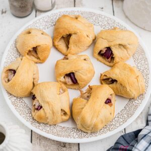 Overhead cropped square image of a plate full of leftover turkey roll ups.