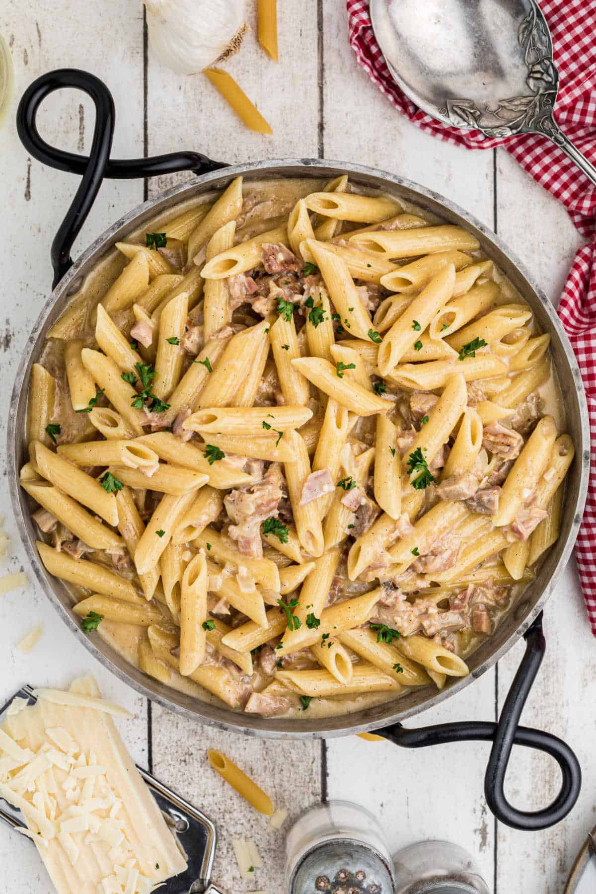 Spoon on the side, a one pot turkey pasta with some cheese on the side.