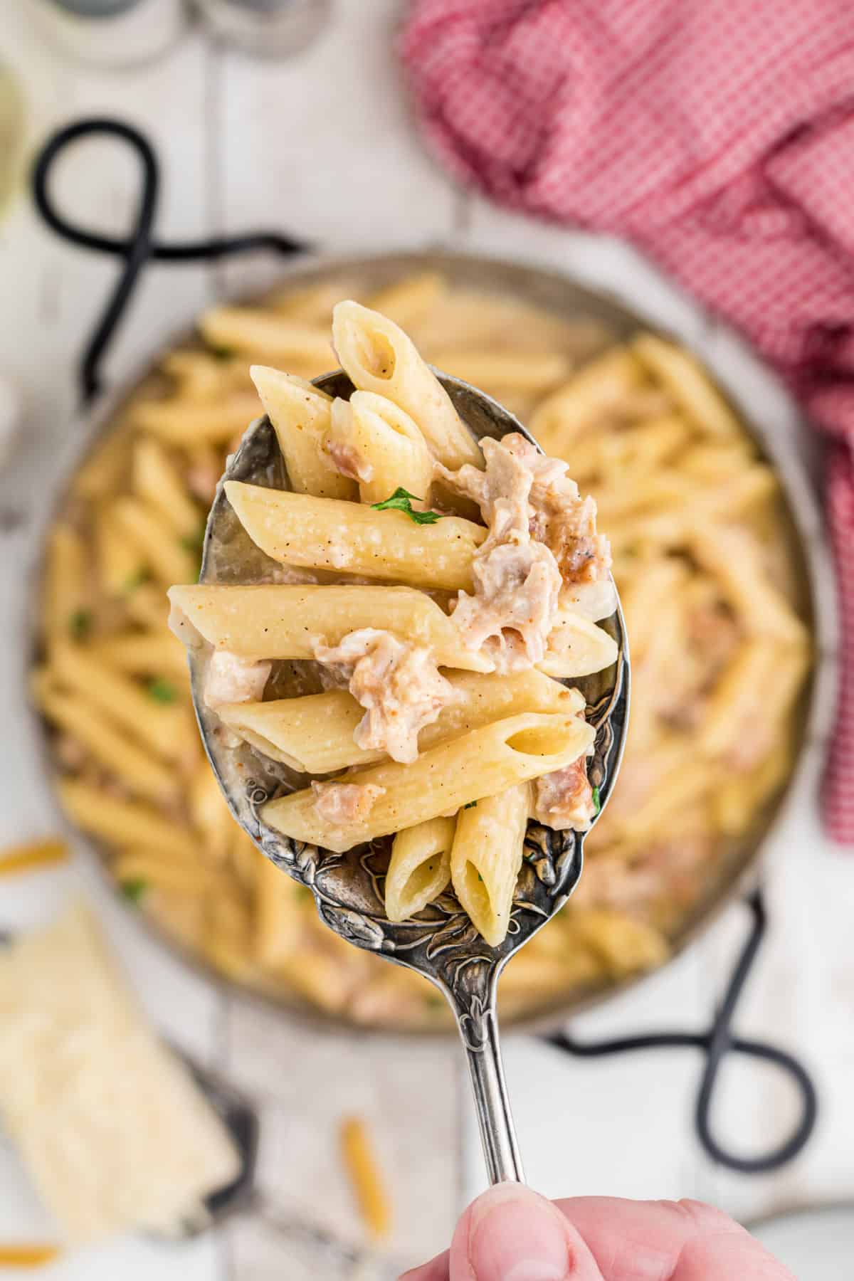 One pot turkey pasta with a spoonful shown close up.