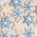 Long image of some snowflake cookies in white and blue colors.