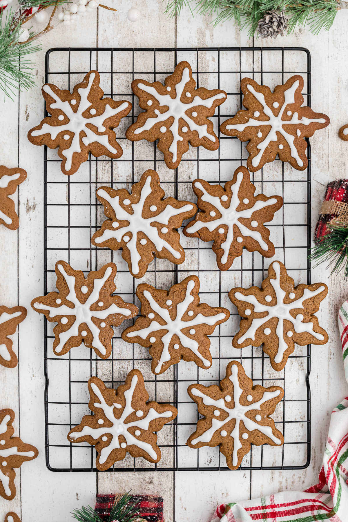 Overhead full on shot of a wire rack filled with gingerbread snowflake cookies.
