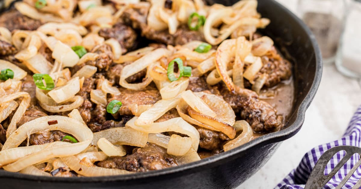 Close up of a cast iron skillet with liver and onions.