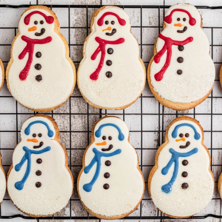 Copycat Starbucks snowman cookies lined up on a cooling rack.