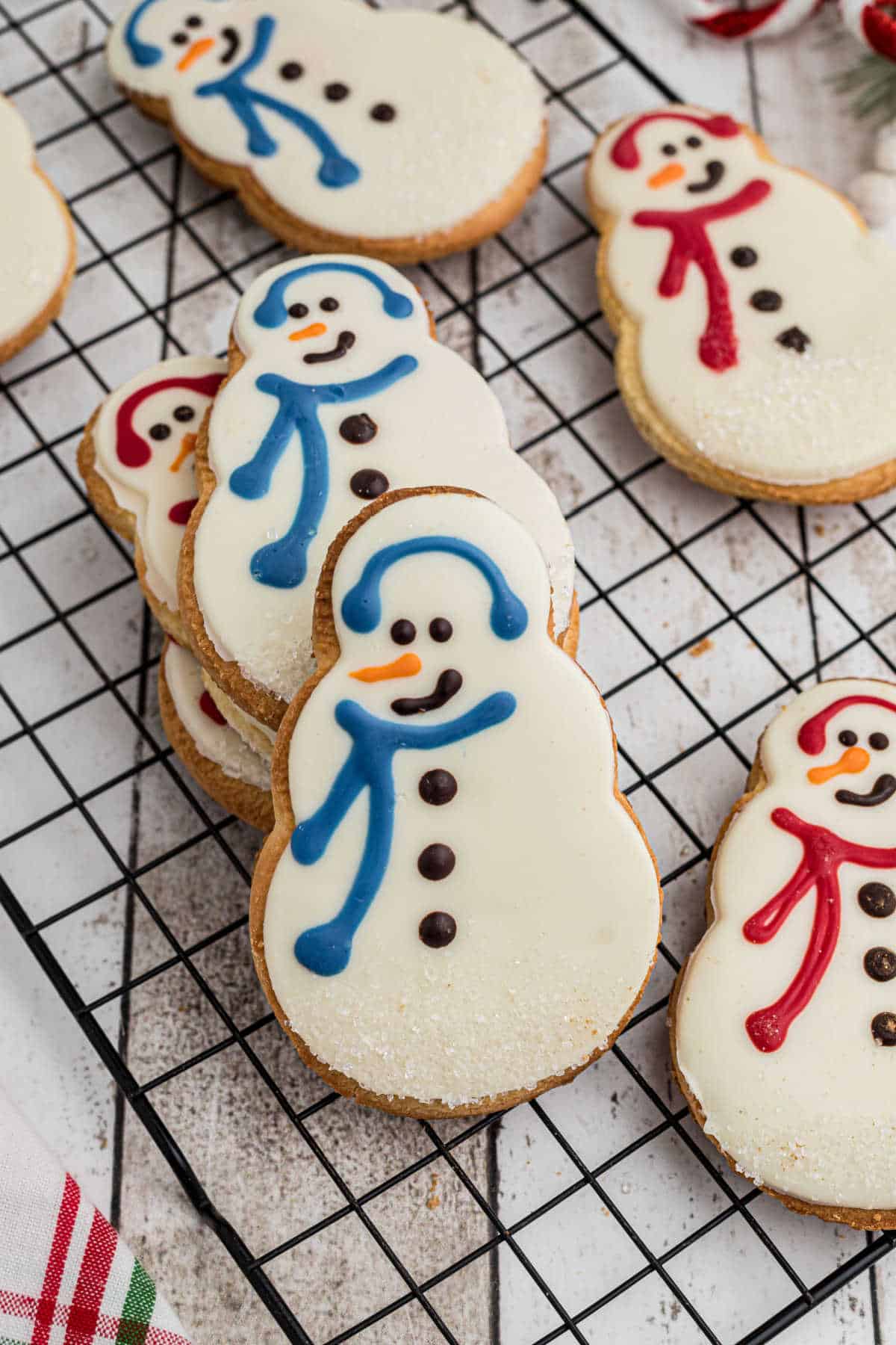 Starbucks snowman cookies up front in a stack on a cooling rack.