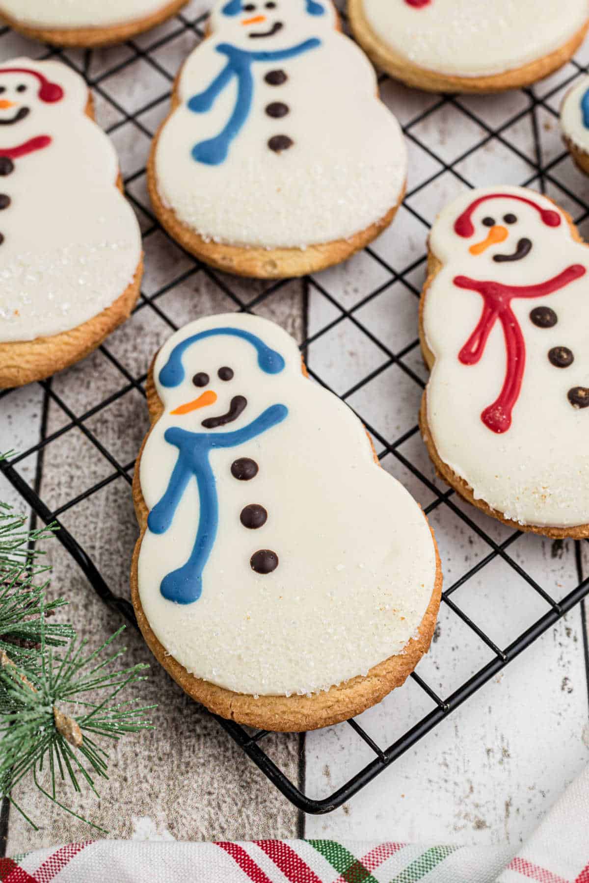 Close up edge of a cooling rack that has a Starbucks snowman cookie recipe.