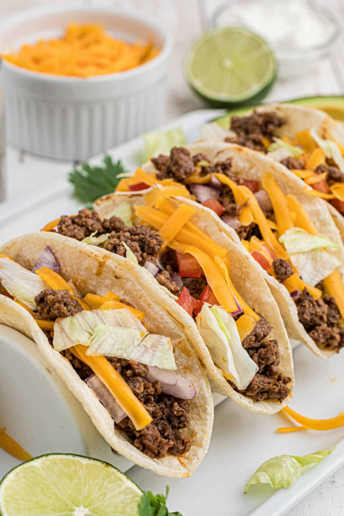 A rack showing a venison taco recipe with cheese in the background.